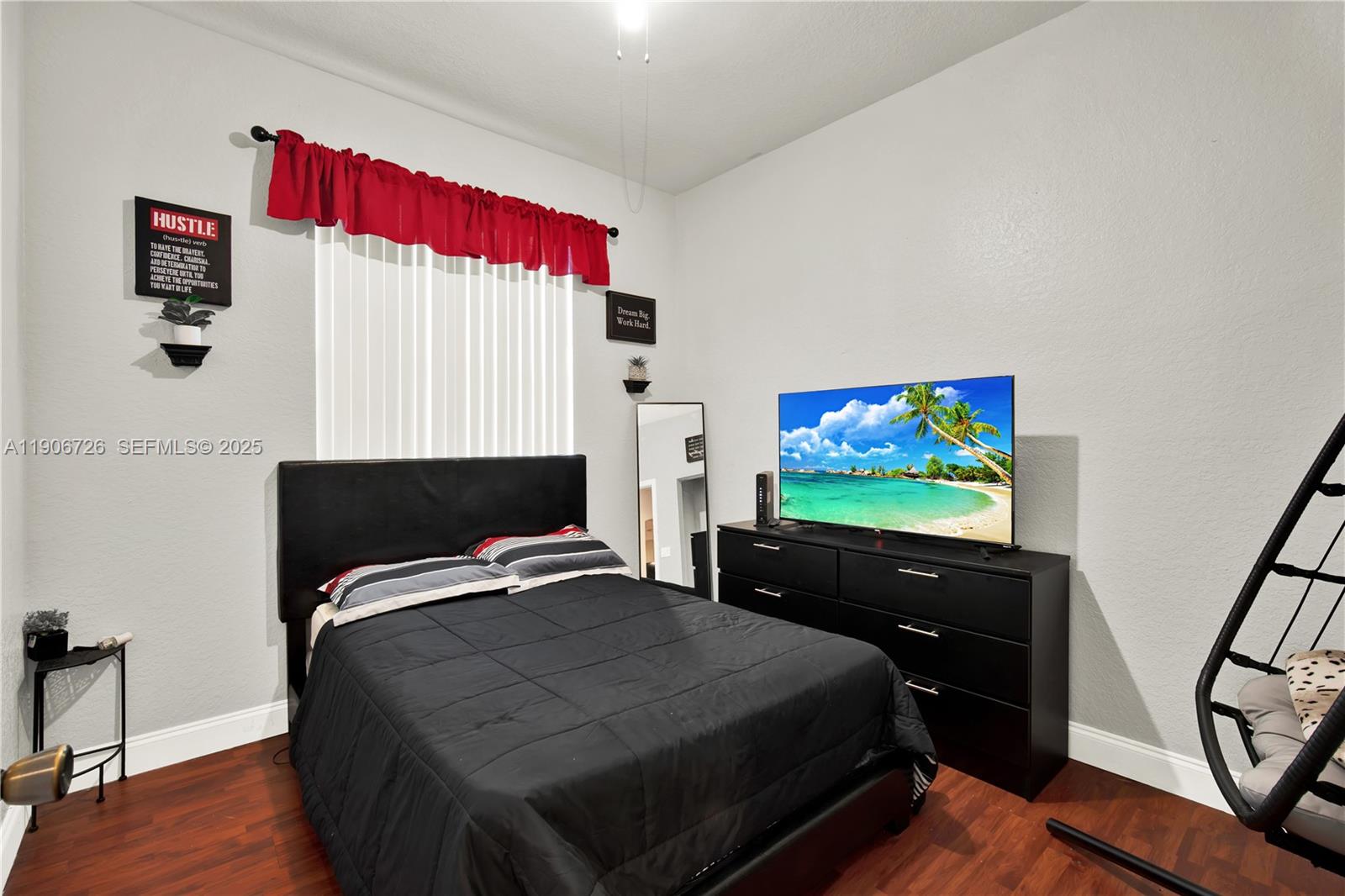 10973 Southwest 238th Street Homestead, FL 33032 - Photo 12 of 25 a bed room with bed and a flat screen tv