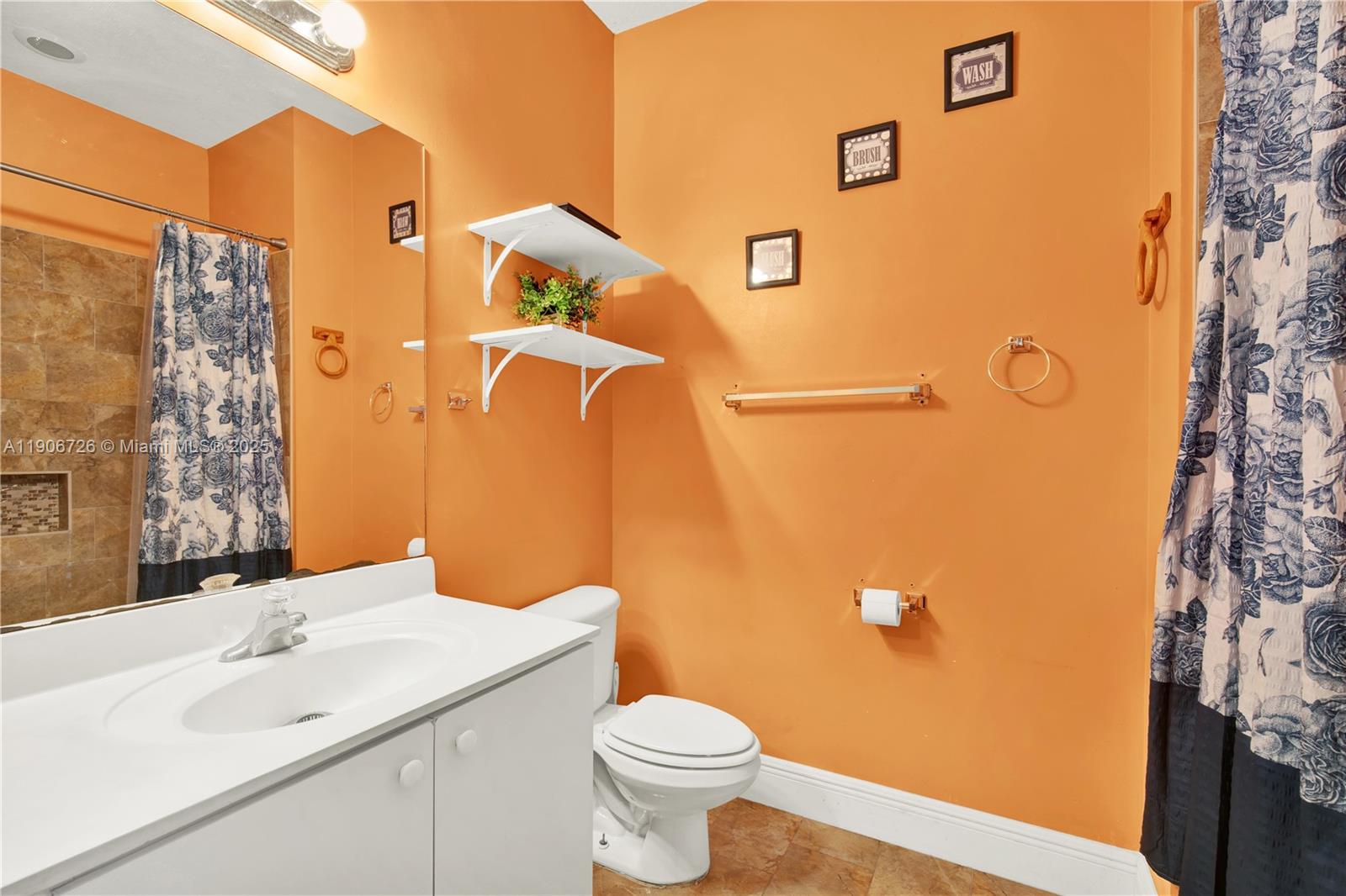 10973 Southwest 238th Street Homestead, FL 33032 - Photo 14 of 25 a bathroom with a sink and mirror with toilet