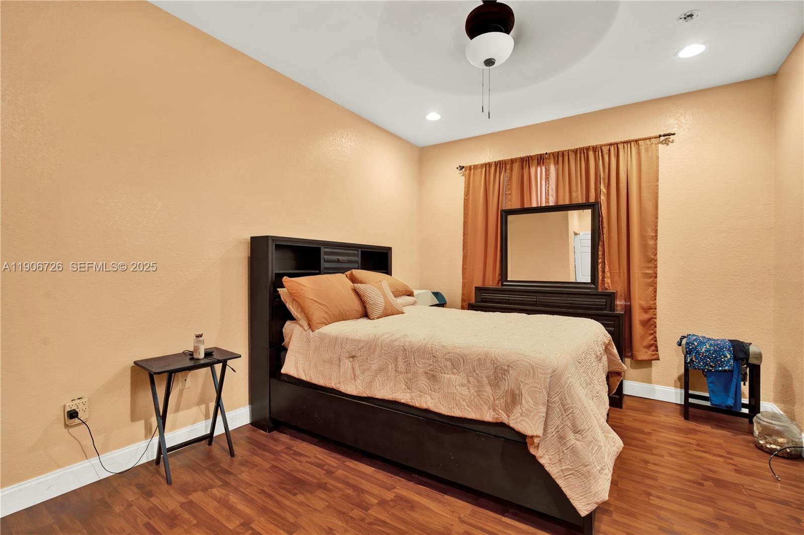 10973 Southwest 238th Street Homestead, FL 33032 - Photo 15 of 25 a bedroom with a bed and wooden floor