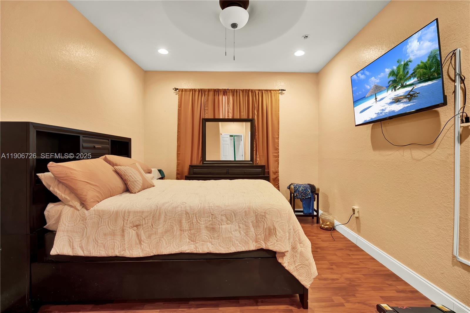 10973 Southwest 238th Street Homestead, FL 33032 - Photo 16 of 25 a bedroom with a large bed and a painting on the wall