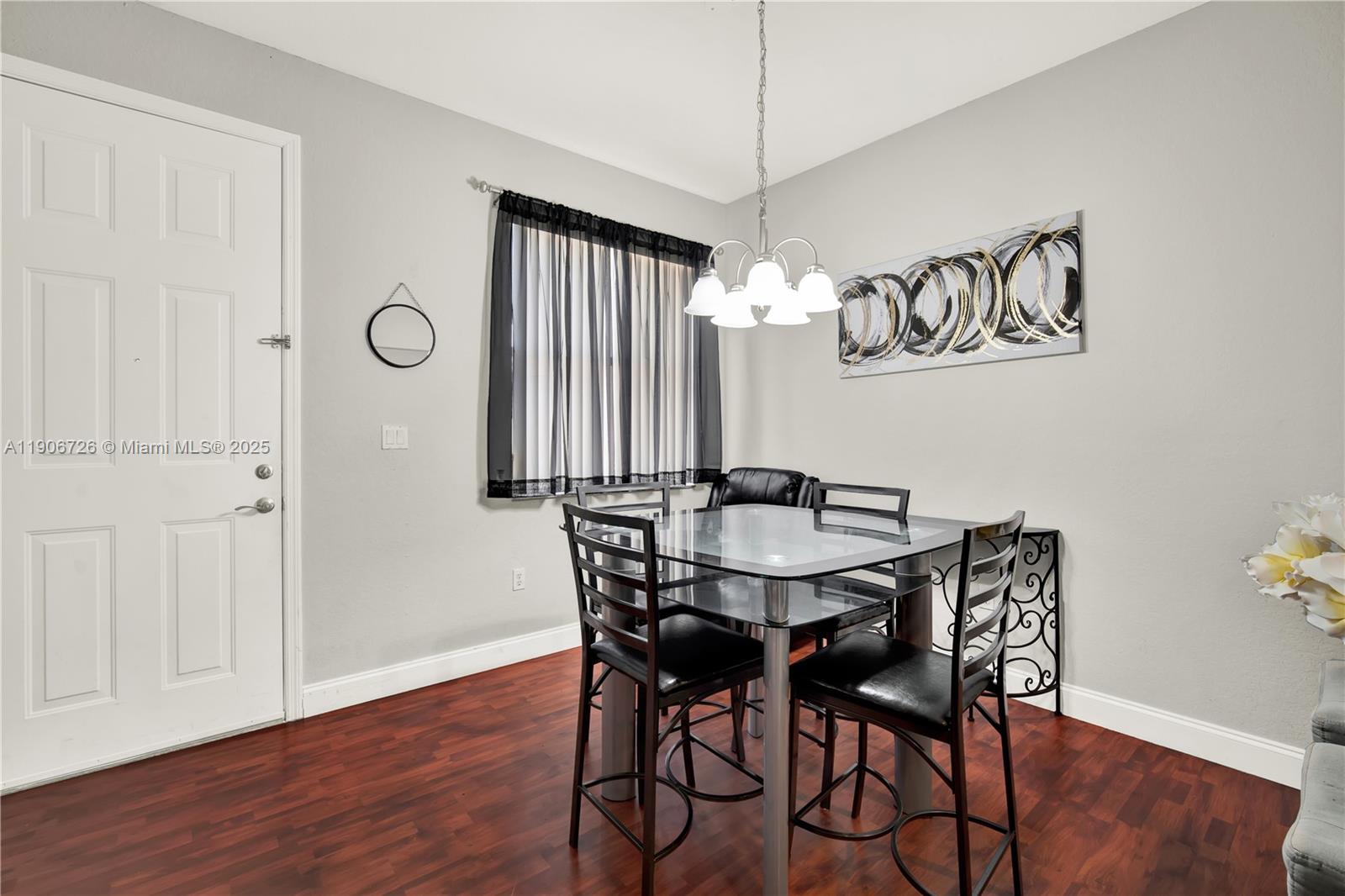 10973 Southwest 238th Street Homestead, FL 33032 - Photo 9 of 25 a view of a dining room with furniture window and wooden floor