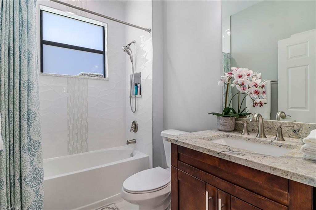 4143 2nd Avenue Northeast Naples, FL 34120 - Photo 12 of 15 a bathroom with a granite countertop sink toilet and shower