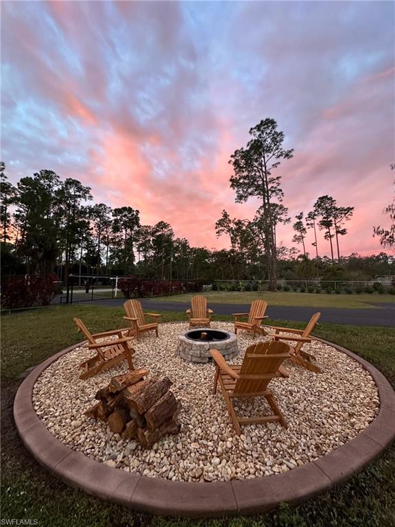 4143 2nd Avenue Northeast Naples, FL 34120 - Photo 14 of 15 a view of a lake with a table and chairs