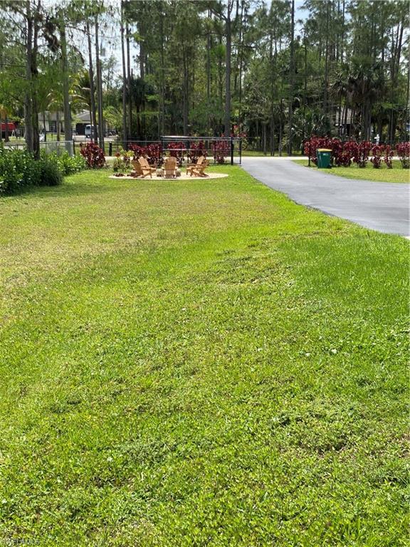 4143 2nd Avenue Northeast Naples, FL 34120 - Photo 2 of 15 a view of outdoor space with garden and trees