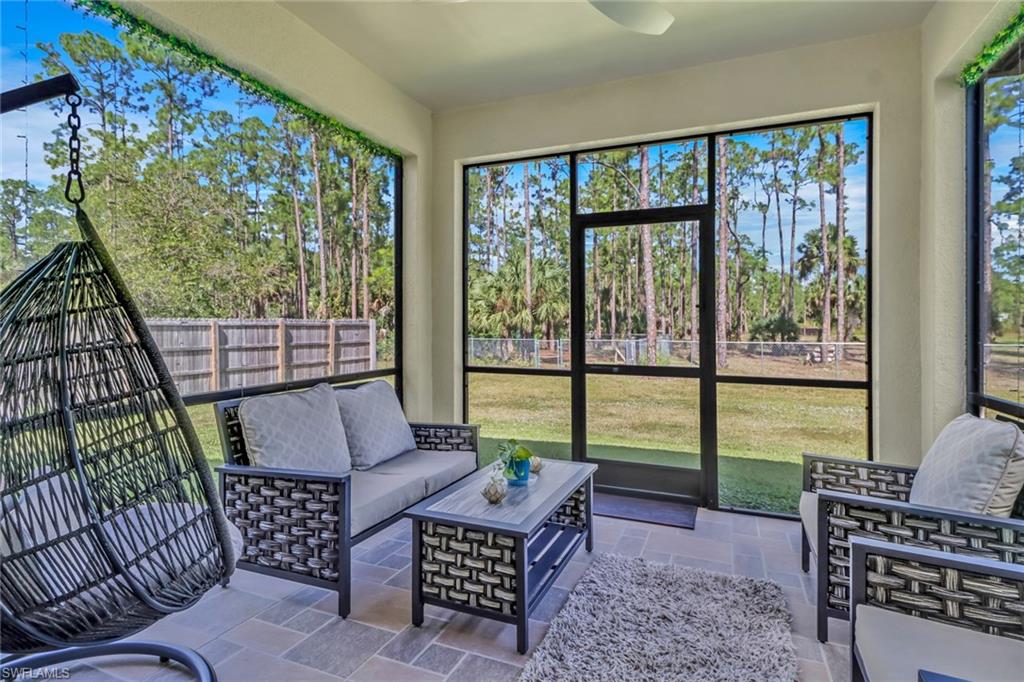 4143 2nd Avenue Northeast Naples, FL 34120 - Photo 3 of 15 a living room with furniture and a floor to ceiling window