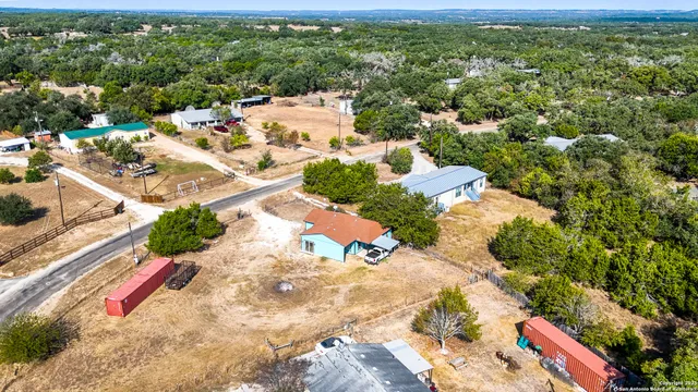 an aerial view of a house with a yard