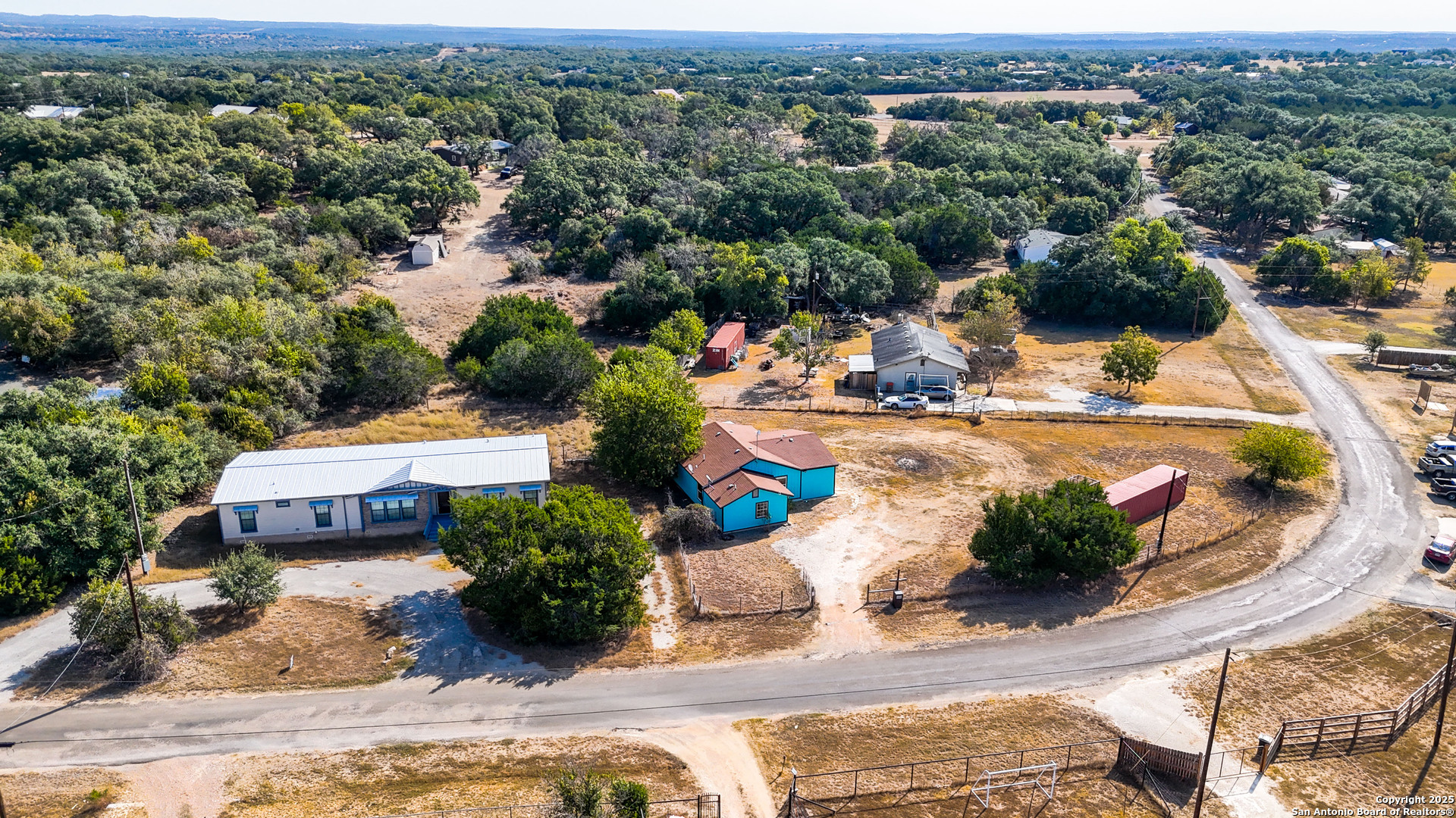 331 Rangeland Road Blanco, TX 78606 - Photo 12 of 49 an aerial view of a house with a garden and lake view