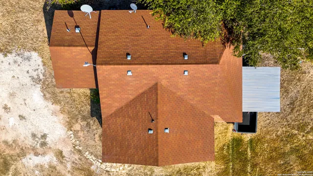 an aerial view of a house with a yard