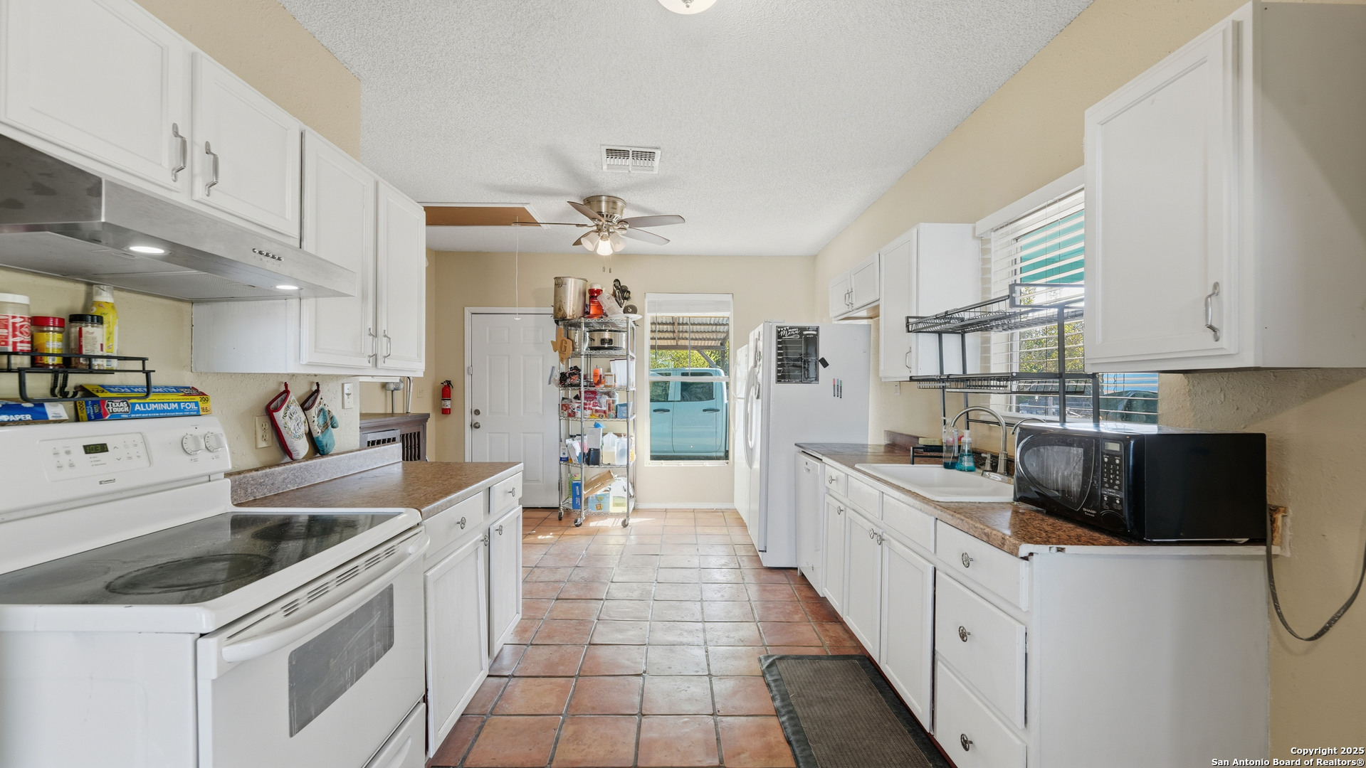331 Rangeland Road Blanco, TX 78606 - Photo 27 of 49 a kitchen with stainless steel appliances a sink stove and cabinets