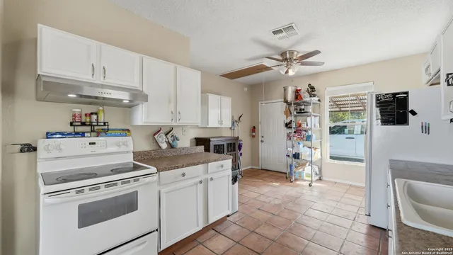a kitchen with a refrigerator and a sink