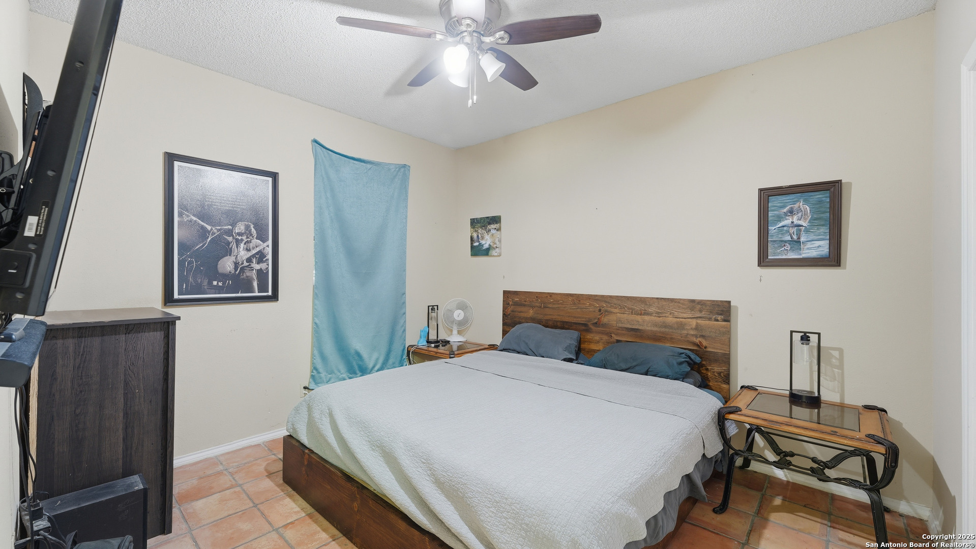 331 Rangeland Road Blanco, TX 78606 - Photo 35 of 49 a bedroom with a bed and a chandelier