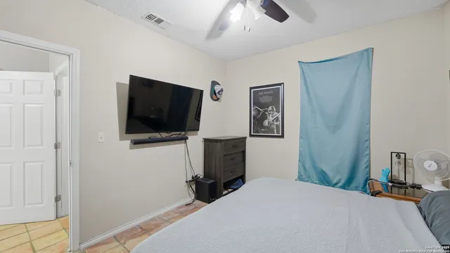 a bedroom with a bed and a television