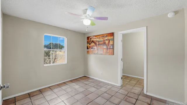an empty room with wooden floor and window
