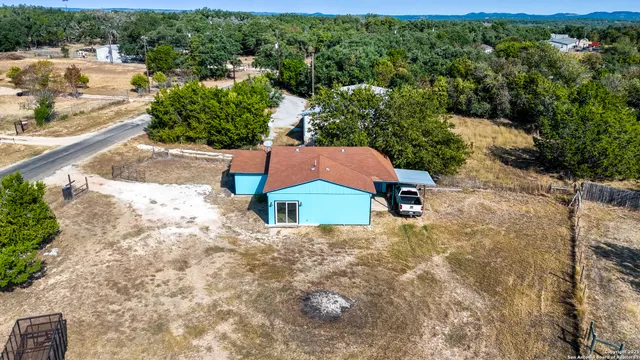 an aerial view of a house with a yard and lake view