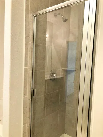 a view of room with a ceiling fan and a window