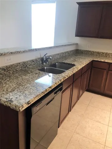 a kitchen with stainless steel appliances granite countertop a stove and a microwave
