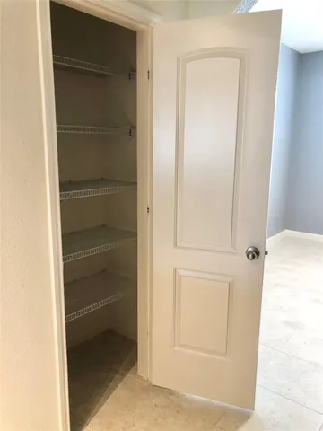 a view of a livingroom with a flat screen tv wooden floor and a ceiling fan