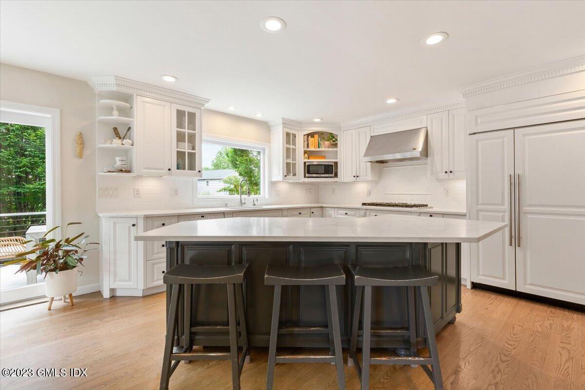 5 Sunshine Avenue Riverside, CT 06878 - Photo 8 of 35 a kitchen with a table chairs refrigerator and cabinets