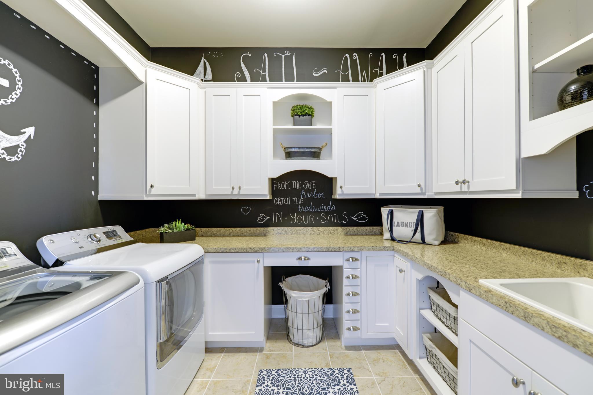 21814 Eastbridge Loop Lewes, DE 19958 - Photo 12 of 14 a kitchen with a sink and cabinets