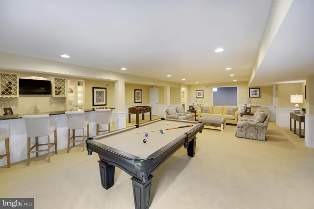 a living room with furniture pool and a flat screen tv