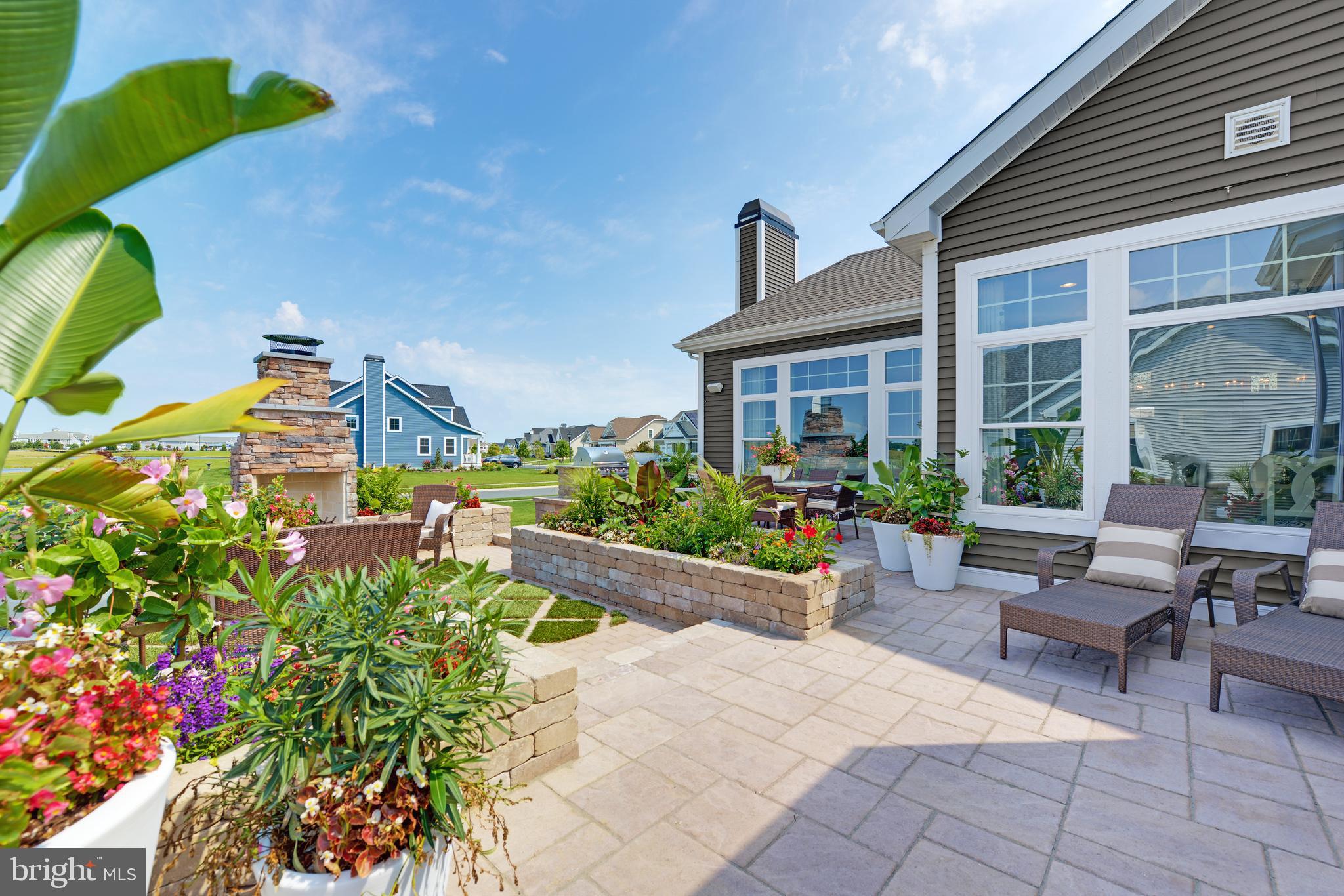 21814 Eastbridge Loop Lewes, DE 19958 - Photo 7 of 14 a view of a patio with couches and table and potted plants