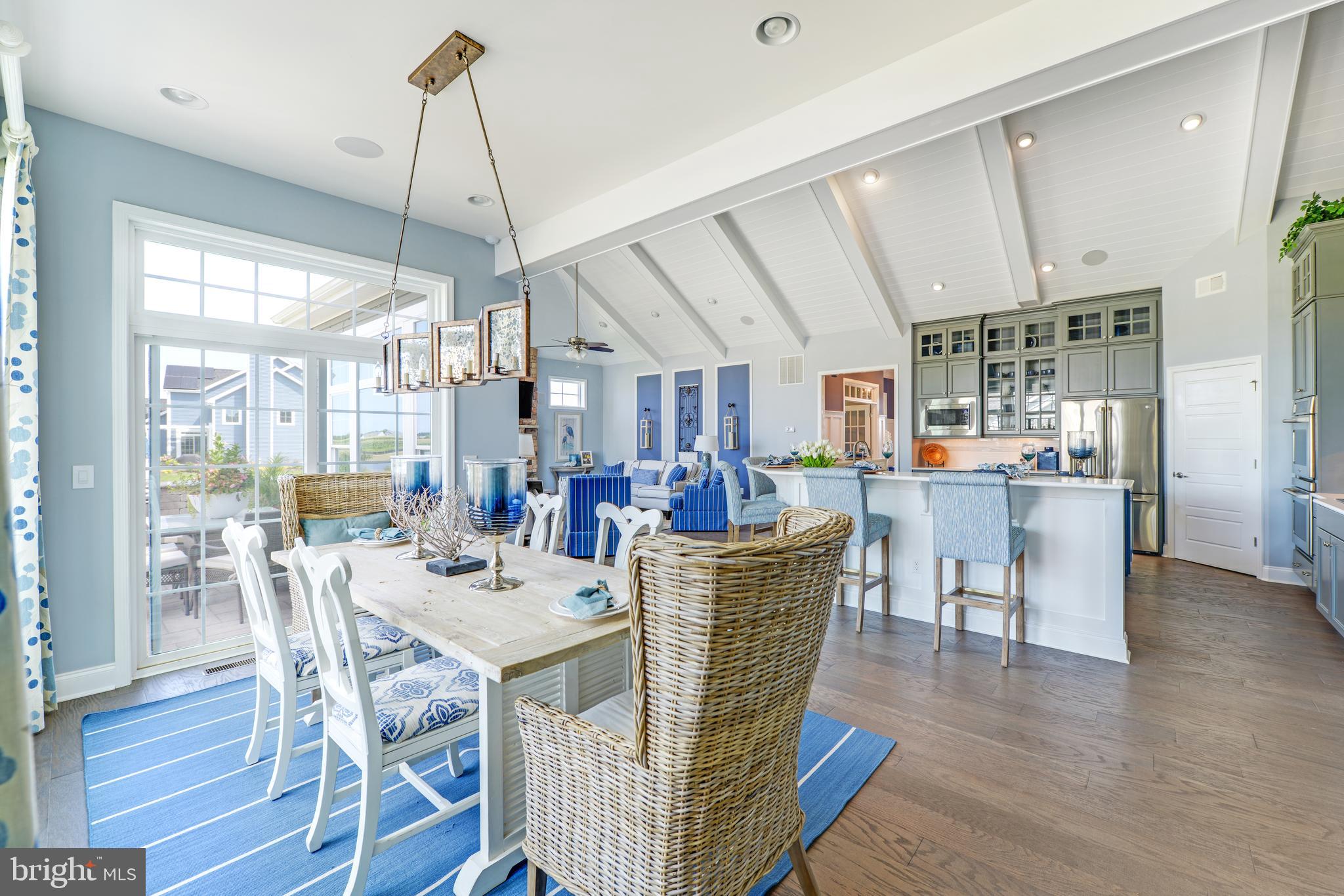 21814 Eastbridge Loop Lewes, DE 19958 - Photo 10 of 14 a view of a dining room and livingroom with furniture wooden floor a chandelier