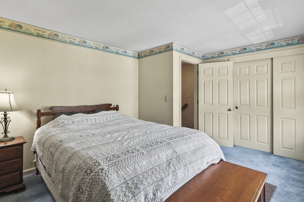 34 Century Way, Unit 34 Gardner, MA 01440 - Photo 14 of 30 a bedroom with a bed and a mirror on the dresser