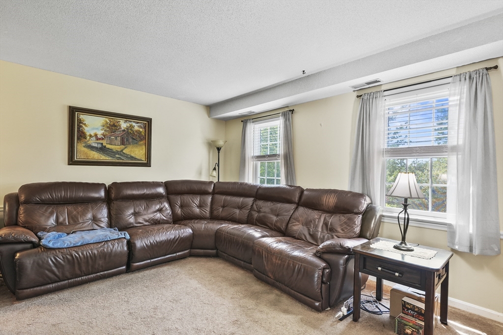 34 Century Way, Unit 34 Gardner, MA 01440 - Photo 2 of 30 a living room with furniture and a window