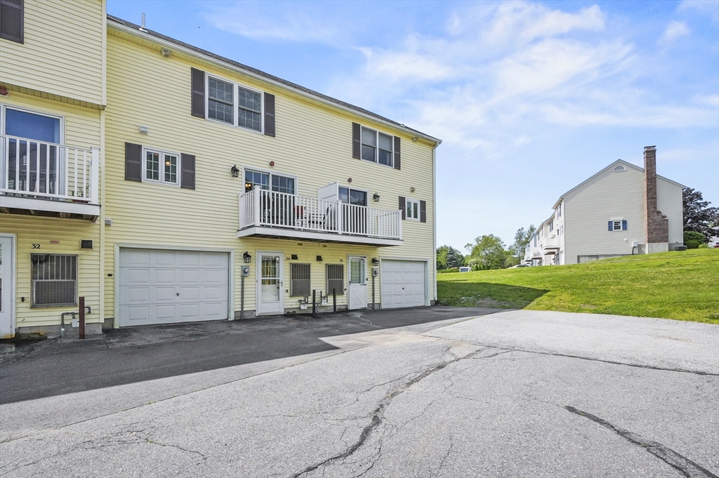 34 Century Way, Unit 34 Gardner, MA 01440 - Photo 23 of 30 a front view of a house with a yard and garage