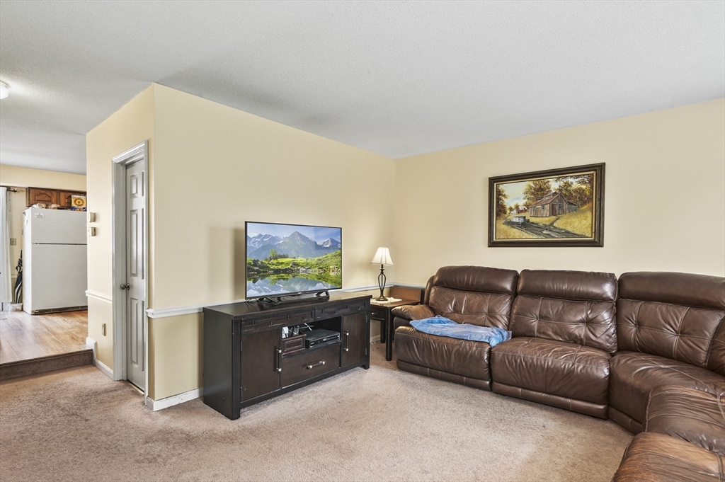 34 Century Way, Unit 34 Gardner, MA 01440 - Photo 4 of 30 a living room with furniture and a flat screen tv
