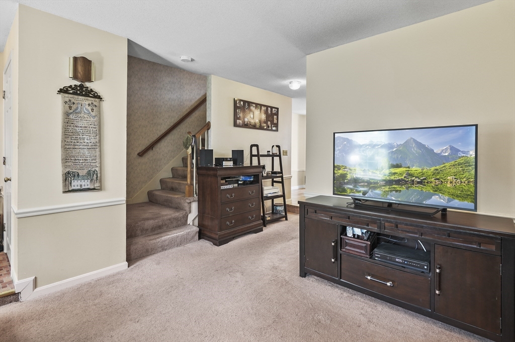 34 Century Way, Unit 34 Gardner, MA 01440 - Photo 5 of 30 a living room with furniture and a flat screen tv