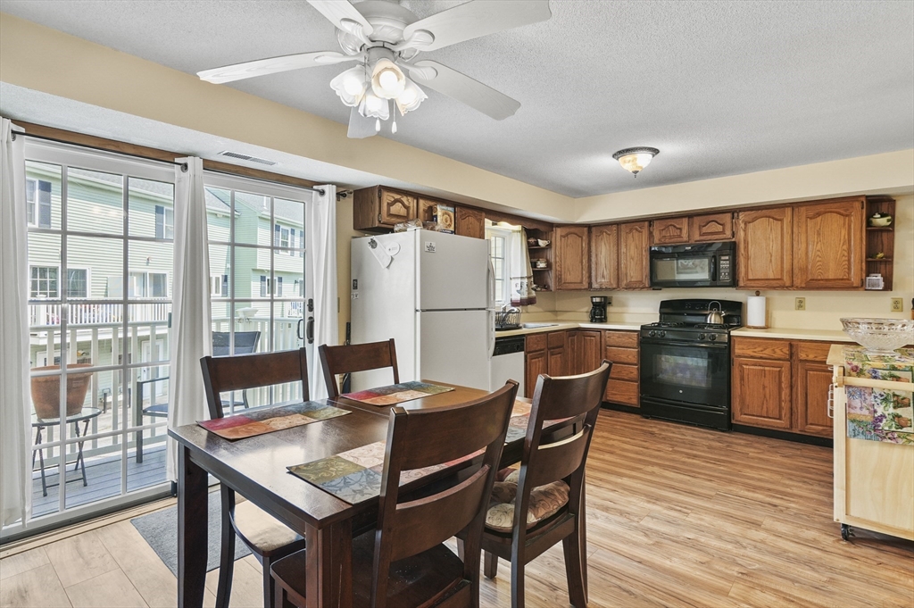 34 Century Way, Unit 34 Gardner, MA 01440 - Photo 8 of 30 a kitchen with stainless steel appliances granite countertop a stove a refrigerator a sink a dining table and chairs