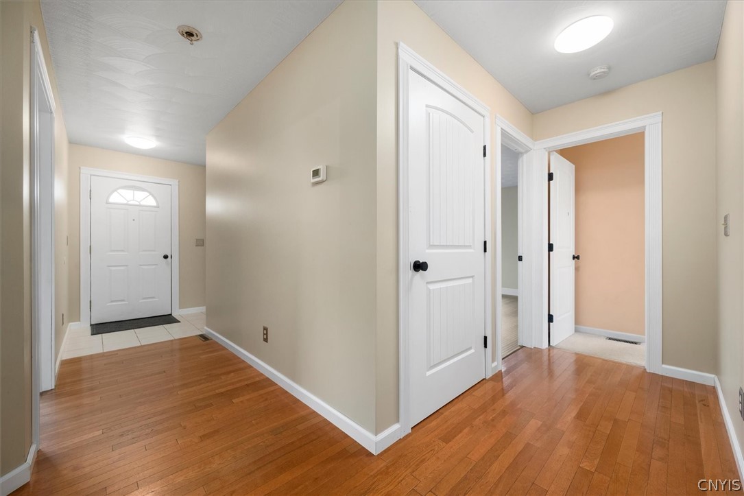 1322 Sawmill Road Sangerfield, NY 13480 - Photo 18 of 50 Rich wood flooring connects the inviting entryway and hallways of this home.