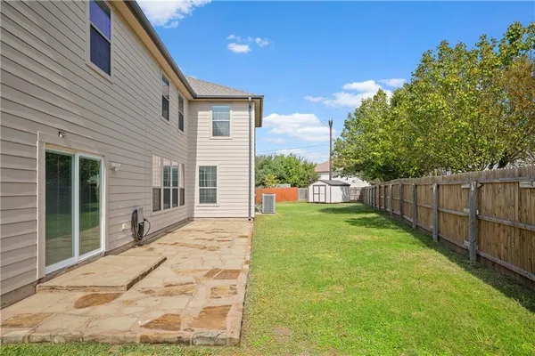 a view of a backyard with wooden fence