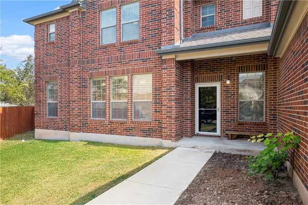 a view of front door of house with a yard