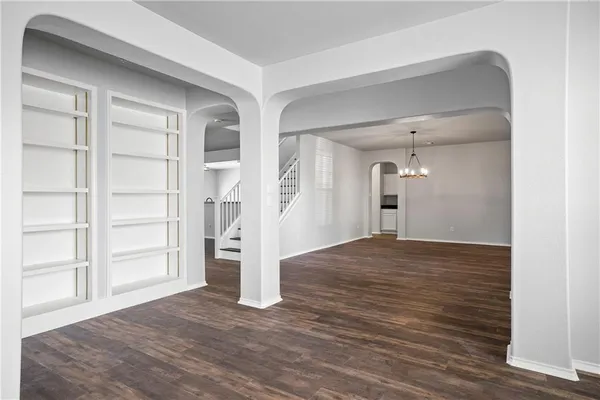 a view of empty room with wooden floor and cabinet