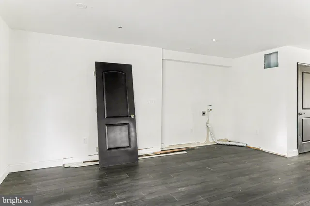 an empty room with wooden floor and closet