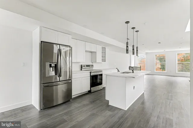 a kitchen with a refrigerator and a sink