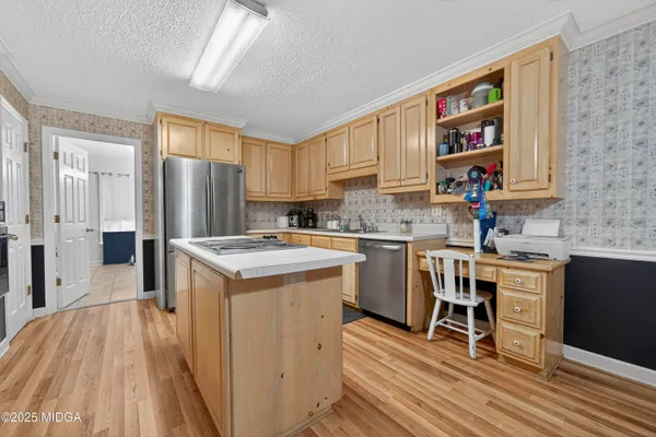 a kitchen with a sink appliances and cabinets
