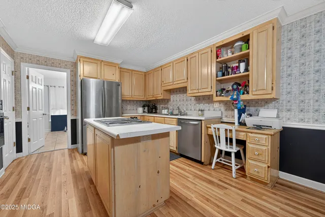 a kitchen with a sink appliances and cabinets