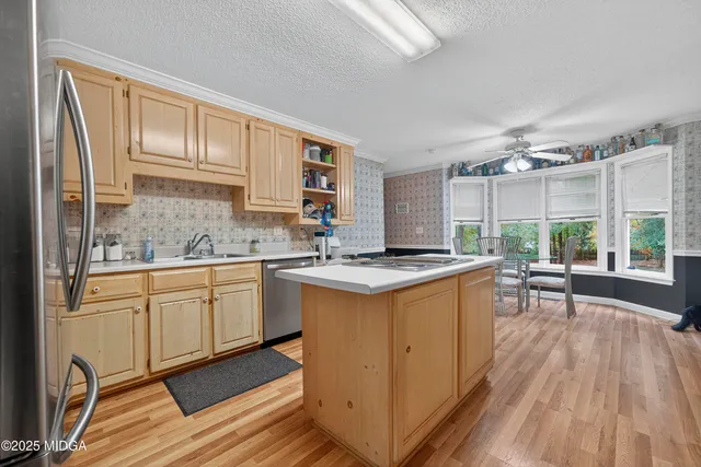 a kitchen with sink cabinets and wooden floor