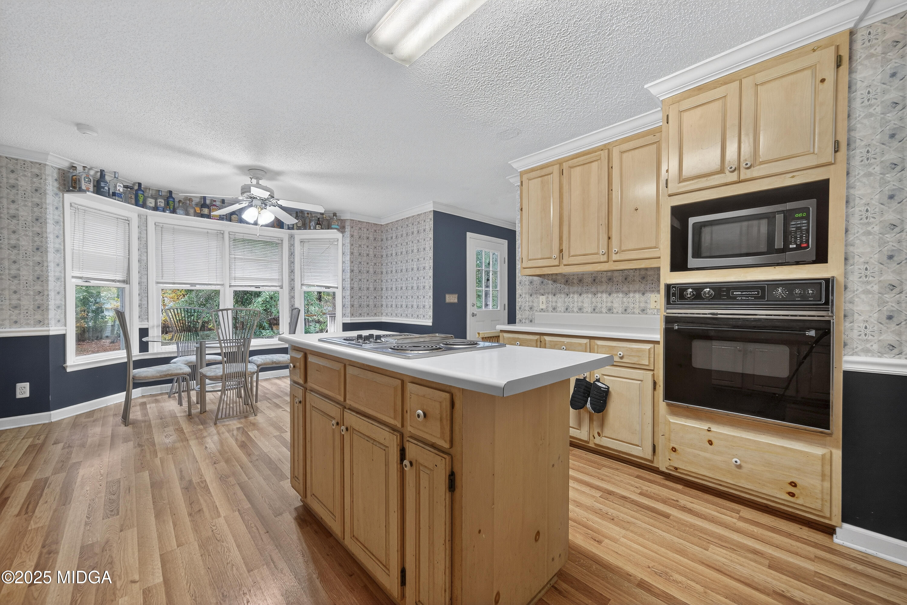 181 Rivoli Landing Macon, GA 31210 - Photo 18 of 37 a kitchen with stainless steel appliances granite countertop a stove top oven a sink dishwasher a dining table and chairs with wooden floor