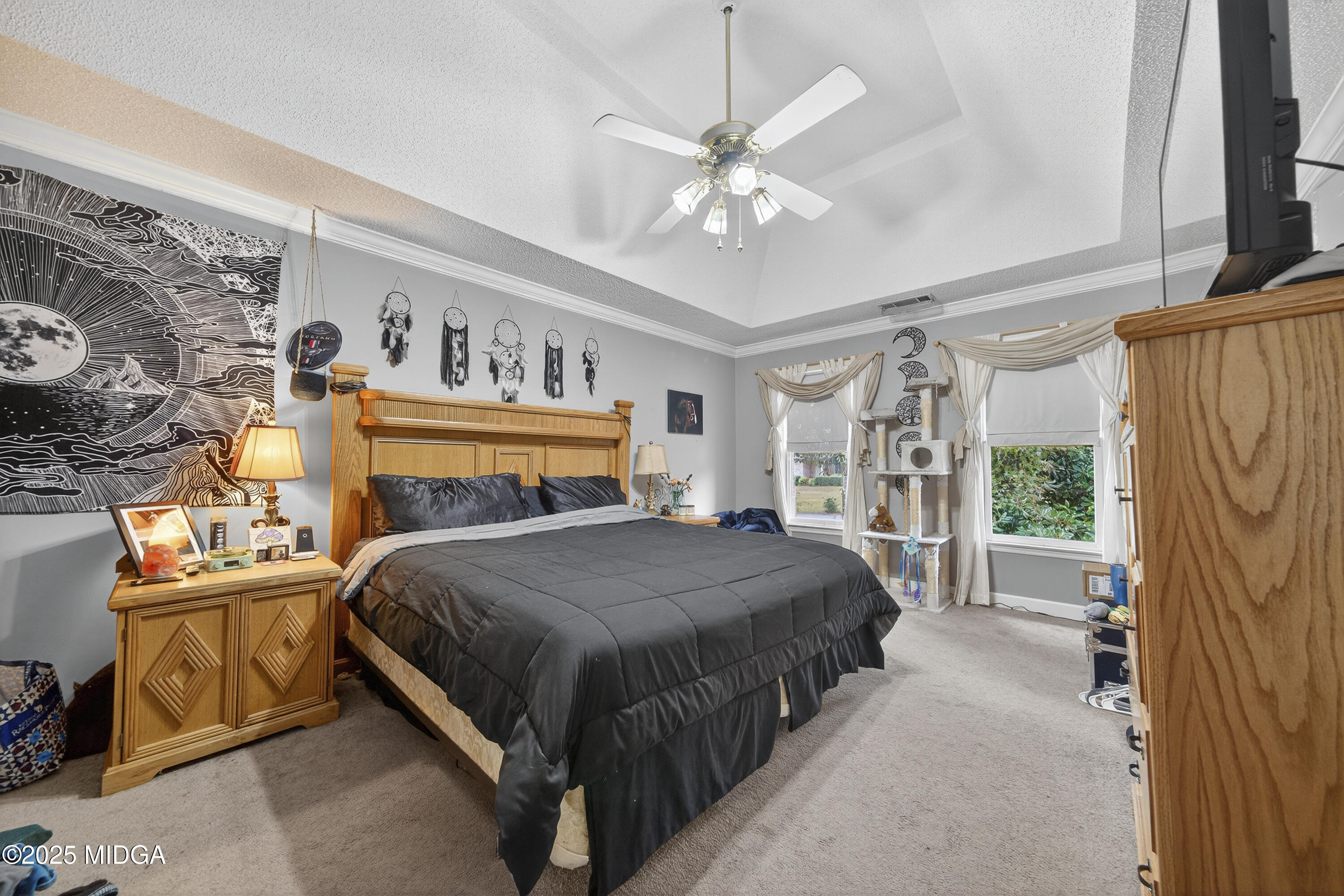 181 Rivoli Landing Macon, GA 31210 - Photo 28 of 37 a bedroom with a large bed and a chandelier