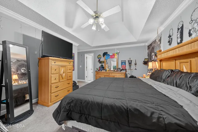 a bedroom with a bed and dresser