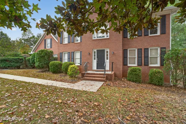 a front view of a house with a yard