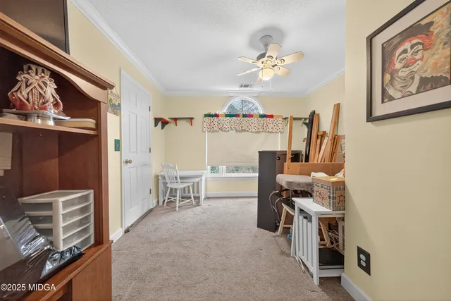 a view of a workspace with furniture and a window