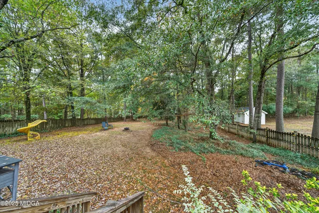 a backyard of a house with lots of green space
