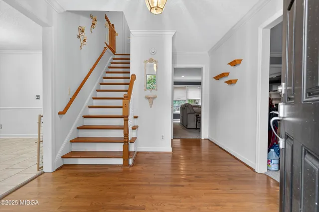 a view of an entryway with wooden floor