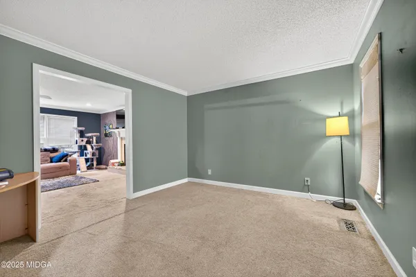 a view of a livingroom with dining area closet and bathroom