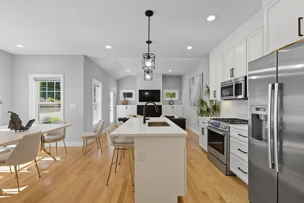 a kitchen with stainless steel appliances granite countertop a sink refrigerator stove and microwave